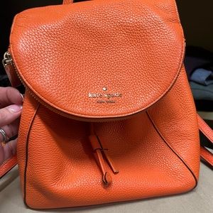 Adorable orange Kate Space backpack for daily use or a night out.